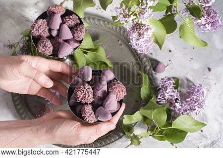 Belgian Sweets Cuberdon And Pralines In Silver Glasses, Spring Still Life With Lilac Flowers, Flat L