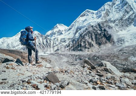 Young Hiker Backpacker Female Taking Brake In Hike Walking Enjoying Khumbu Glacier. High Altitude Ev
