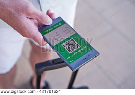 Smartphone In Hand Displaying On App Mobile Valid Digital Green Vaccination Certificate For Covid-19