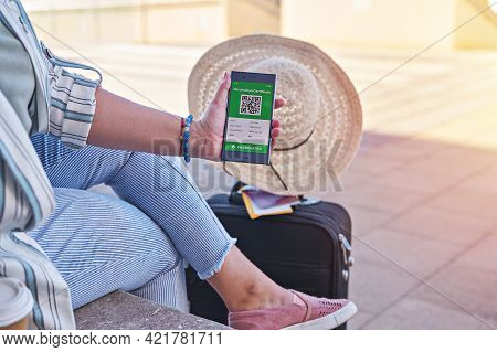Woman Using Digital Health Vaccination Passport App On Mobile Phone For Travel During Covid-19 Pande