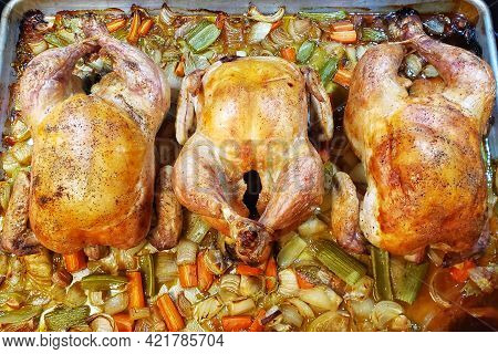 Three Whole Cooked Chickens On A Pan Fresh Out Of The Oven