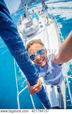 Little Boy On Board Of Sailing Yacht On Summer Cruise. Travel Adventure, Yachting With Child On Fami