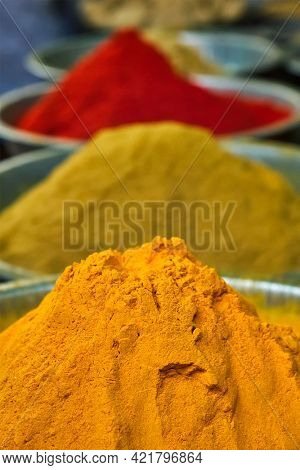Turmeric curcuma powder and chili powder in spices market in India. Sardar Market, Jodhpur, Rajasthan, India