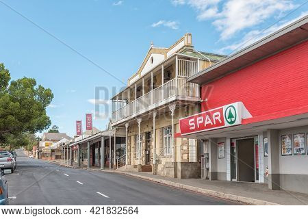 Oudtshoorn, South Africa - April 5, 2021: A Street Scene, With Businesses And Vehicles, In Oudtshoor