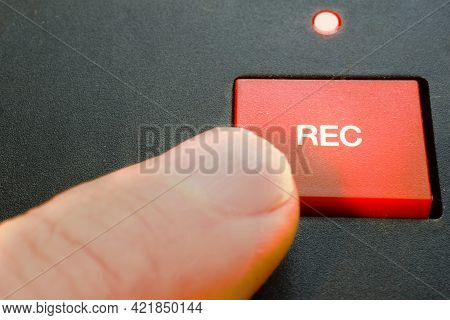Record. A Finger Pushes Rec / Recording Button