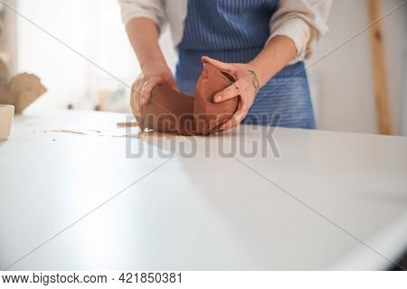 Focused Photo On Hands Holding Pieces Of Fireclay