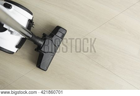 Bagless Cyclone Vacuum Cleaner On A Laminate. Electrical Apparatus That By Means Of Suction Collects