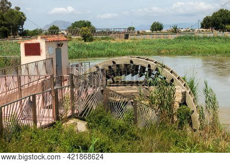 Water Wheel Pump Used To Provide Water For Orchard Irrigation