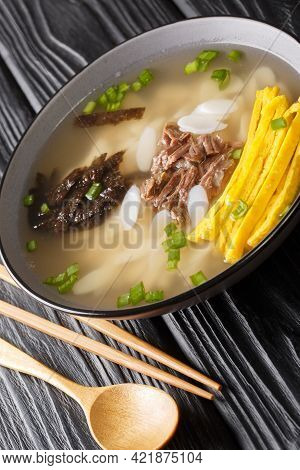 Hearty And Comforting Korean Rice Cake Soup Tteokguk Closeup In The Bowl On The Table. Vertical