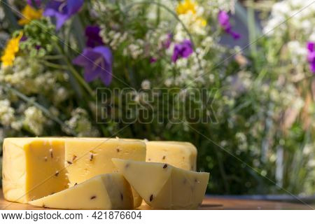 Sliced Cheese With Cumin On A Wooden Table. Celebration Of A Traditional Holiday In Latvia Ligo In J
