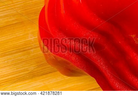 Stacked Pile Of Sliced Fresh Red Paprika, Bell Pepper On Bamboo Cutting Board
