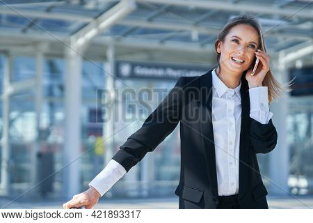 Adult female passenger using smartphone at the airport