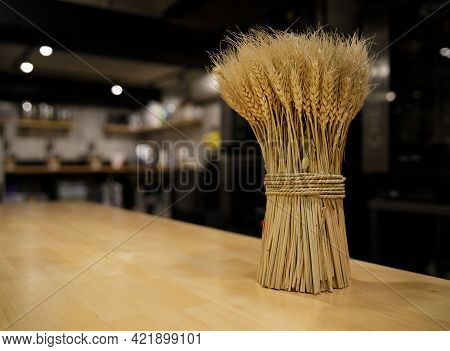 Reap Of Dry Wheat Beautifully Pulled With Spikes Stands On A Table In A Cafe