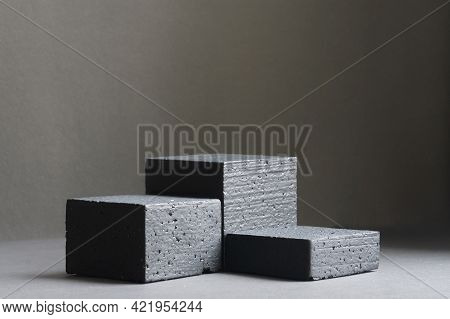 Three Black Square Stands, Of Different Heights, On Black Background. Platforms For Presentation Of 