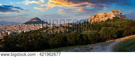 Panorama of famous greek tourist landmark - the iconic Parthenon Temple at the Acropolis of Athens as seen from Philopappos Hill on sunset. Athens, Greece