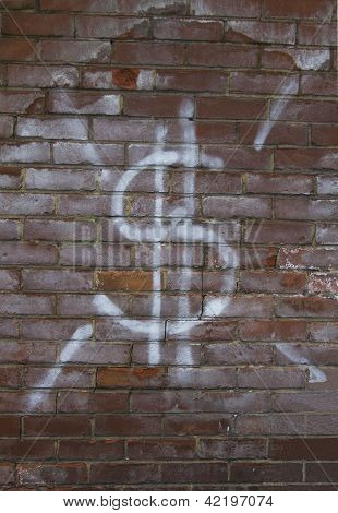 Znak dolara na mur z cegły