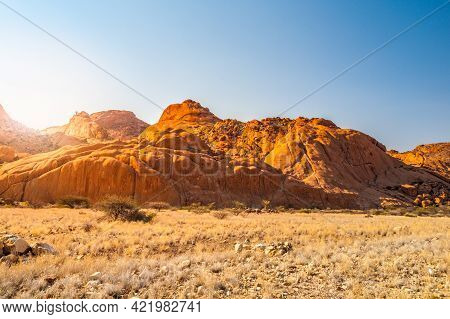 Pontok Mountains Near Spitzkoppe. Red Vivid Granite Rock Formation In Namib Desert At Sunset Time, N