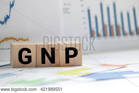 Gnp Gross Domestic Product Word Made With Wooden Blocks On Grey Blue Background.