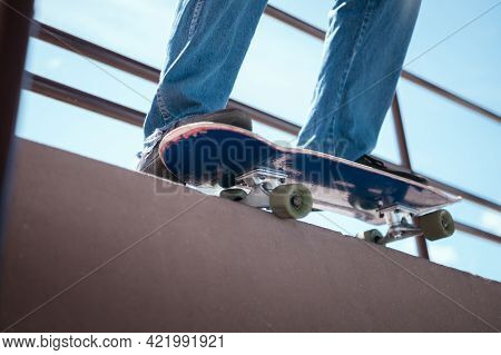 Skateboarder Jumping High On Mini Ramp At Skate Park Outdoor.
