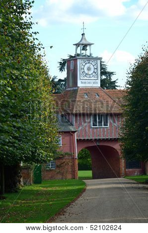 Gatehouse and clock through trees