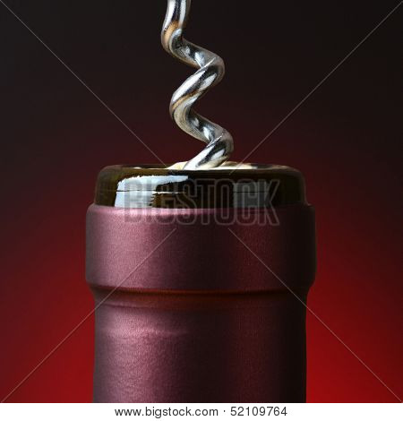 Closeup of the neck of a wine bottle with a corkscrew partially in the cork.