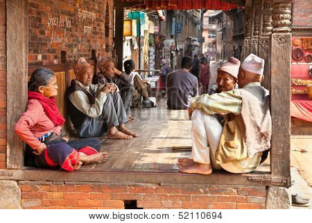 BHAKTAPUR - MAY 20 : Unidentified Tharu old people besides the street of Bhaktapur, Nepal on May 20, 2013. Tharu are an ethnic group from west part of Nepal.