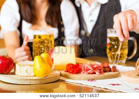 Couple in a traditional mountain hut having a meal