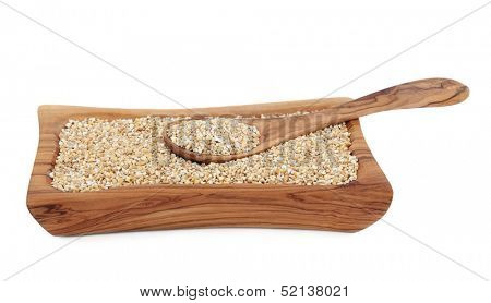 Pinhead oatmeal breakfast cereal in an olive wood bowl.