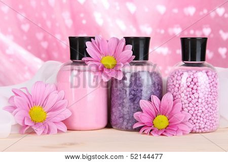 Aromatherapy minerals - colorful bath salt on pink background