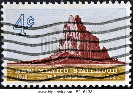 stamp shows Shiprock Mountain New Mexico Statehood 50th anniversary