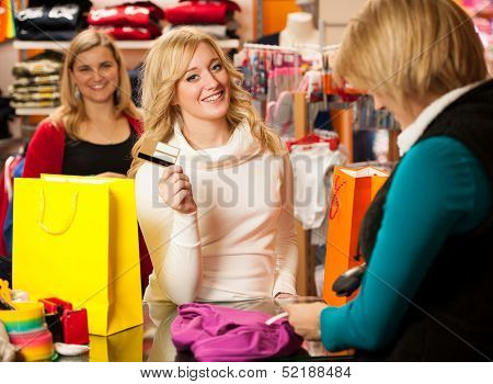 Cute Young Woman Paying After Succesfull Purchase With Credit Card