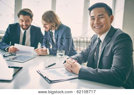 Portrait of a businessman in board room looking at camera 