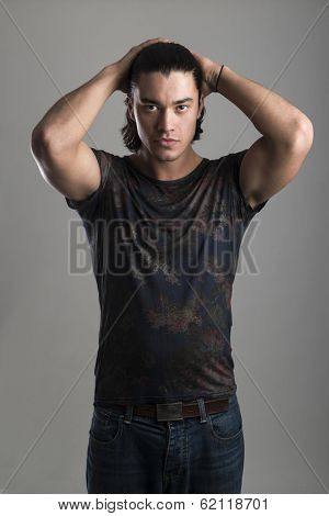 Portrait of handsome Malaysian man wearing flowery top with hands on hair