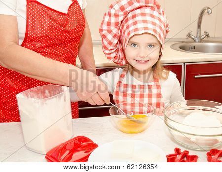 Little Girl And Grandmother Stirrring Cookie Dough