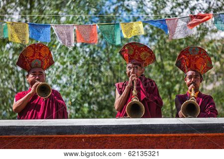 HUNDER, INDIA - SEPTEMBER 6, 2011: Tibetan Buddhist monks playing traditional musical instruments. Hunder, Nubra valley, Ladakh, India