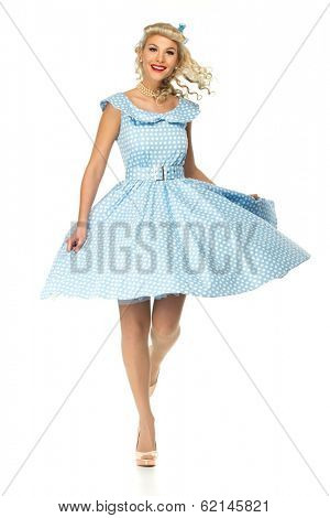 Sexy coquette blond pin up style young woman in blue dress