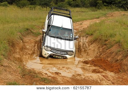 White Toyota Triton Dhd Crossing Mud Obstacle