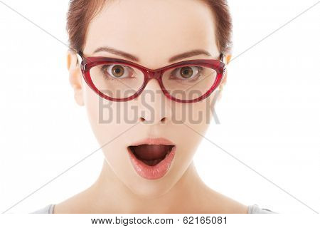 Young surprised woman in eyeglasses. Isolated on white. 