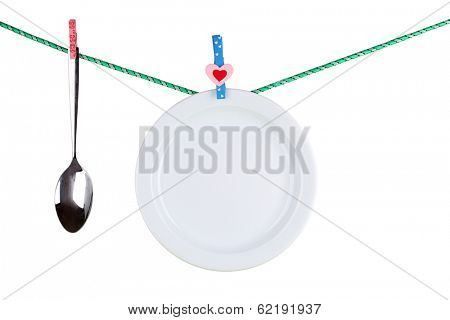 Tableware dried on rope isolated on white