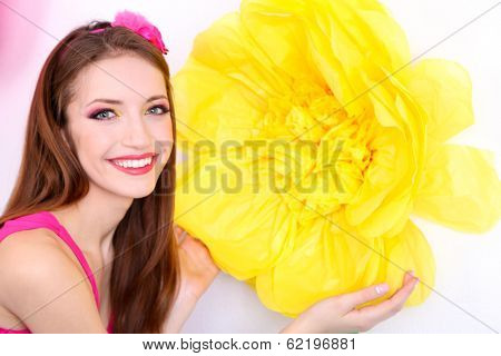 Beautiful young woman in petty skirt with big flower close up