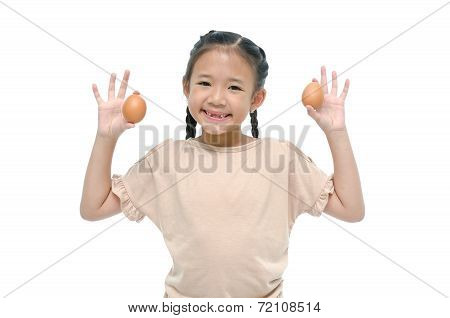 Little asian girl smiiing and holding egg