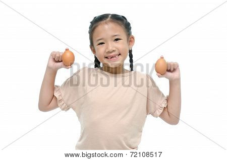 Little asian girl smiiing and holding egg