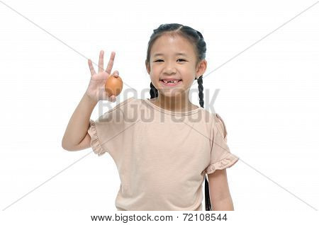 Little asian girl smiiing and holding egg