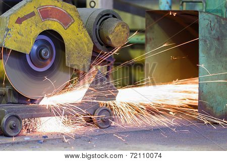 Worker Cutting Metal And Spark By Cutting Machine