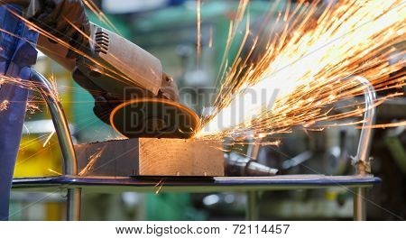 Worker Grinding Steel By Electric Grinding Machine