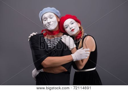 Portrait of funny mime couple with white faces and emotions isol