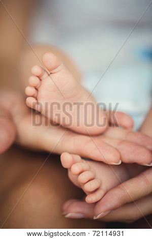 Baby feet in mommy's hands