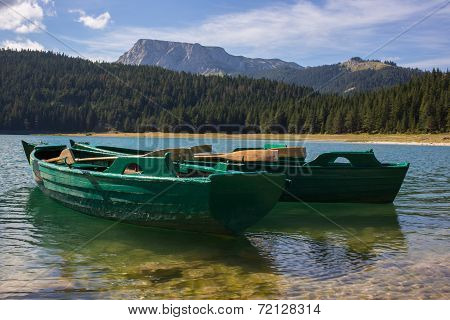 Boats in black lake in Durmitor national park in Montenegro