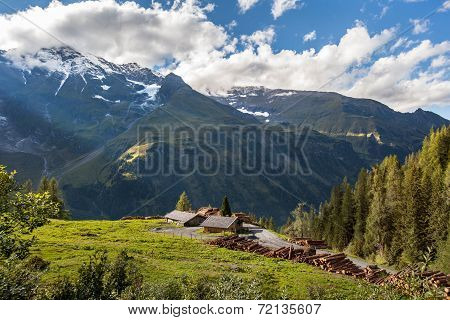 Mountain landscape with sawmill and cut logs