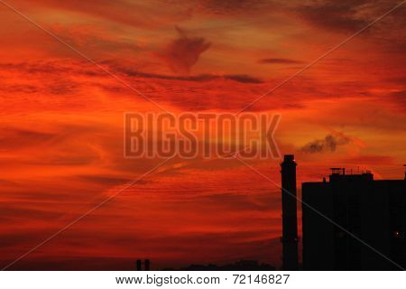 blood red sunset and silhouette of the factory